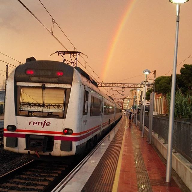 railroad track, rail transportation, railroad station platform, railroad station, public transportation, transportation, train - vehicle, sky, the way forward, power line, street light, passenger train, built structure, public transport, mode of transport, sunset, travel, railway track, illuminated, diminishing perspective