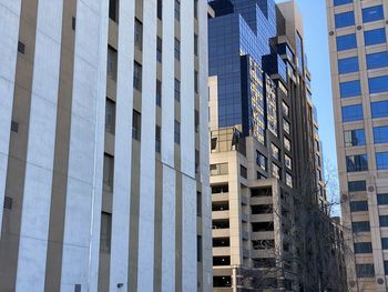 Low angle view of modern glass building in city