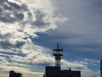 Low angle view of building against cloudy sky