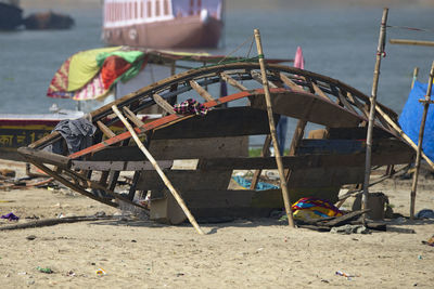 Abandoned boat moored on beach
