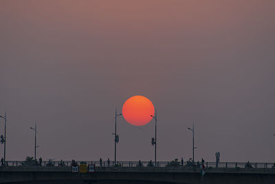 Silhouette of building against clear sky during sunset