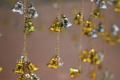 Close-up of small bells hanging outdoors