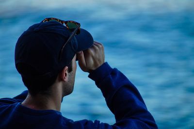 Midsection of man in sea against sky