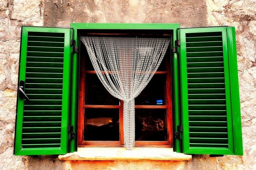 CLOSED WINDOW OF OLD HOUSE