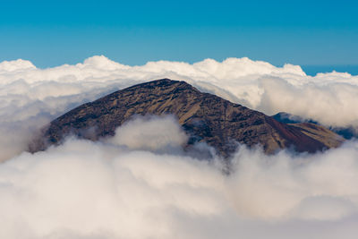Scenic view of mountain amidst cloudscape against sky