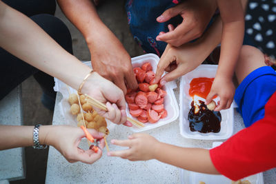 High angle view of hands holding food