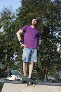 Portrait of skateboarder standing in a ramp