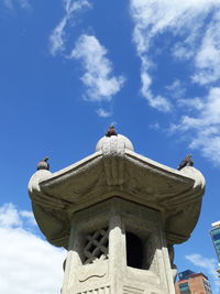 Low angle view of a statue against sky