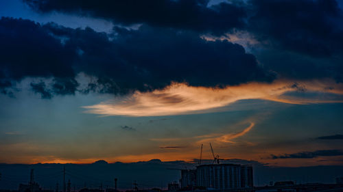 Low angle view of storm clouds over city