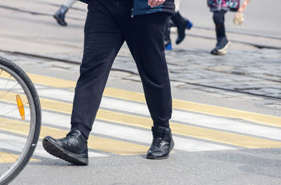 Low section of man with bicycle on street