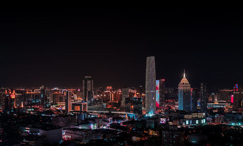 Illuminated buildings in city at night