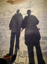 High angle view of people shadow on street