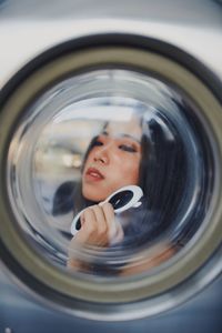 Young woman seen through window