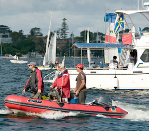 People on boat in sea against sky