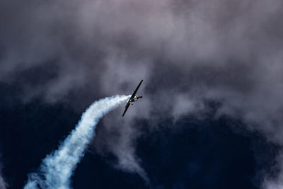 Low angle view of airplane flying against sky