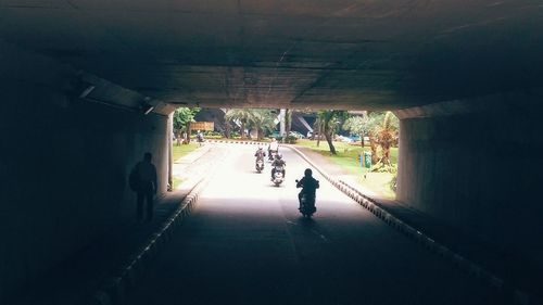 Man walking in illuminated tunnel