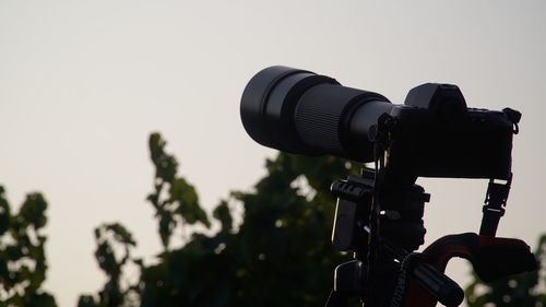 Close-up of home video camera against clear sky