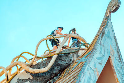 People on boat against clear sky