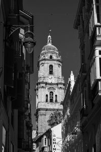 View of malaga cathedral between alleys during the summer..