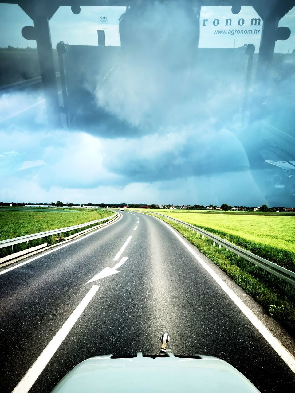 ROAD AGAINST SKY SEEN FROM CAR