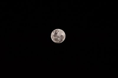 Low angle view of moon against clear sky at night