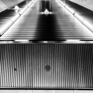 Low angle view of illuminated lights on ceiling