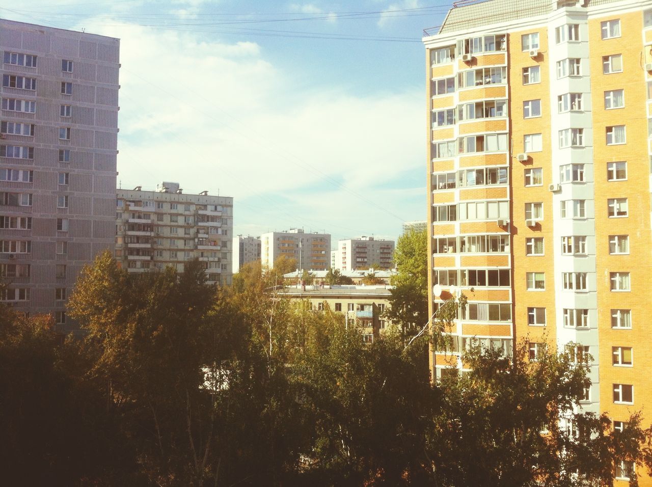 building exterior, architecture, built structure, city, sky, skyscraper, modern, building, office building, residential building, cloud - sky, tall - high, tree, residential structure, tower, residential district, cityscape, cloud, low angle view, city life