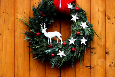 Christmas wreath with reindeer on a front wooden door - close up