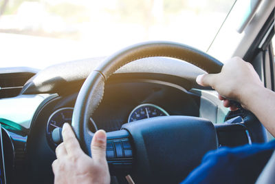 Midsection of man driving car