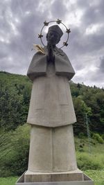 Low angle view of statue against cloudy sky