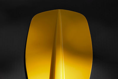 Close-up of yellow lamp against black background