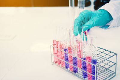 Cropped hand of doctor holding test tubes