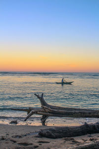 Scenic view of sea against clear sky during sunset