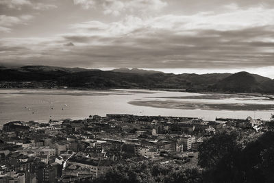 High angle view of townscape by sea against sky