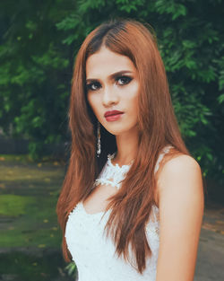 Close-up portrait of young woman standing outdoors