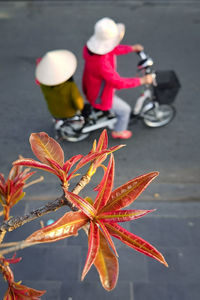 Midsection of woman with bicycle on road in city
