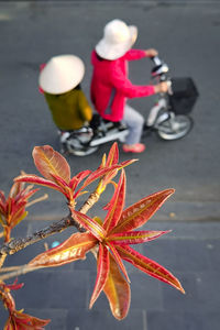 Midsection of woman with bicycle on road in city