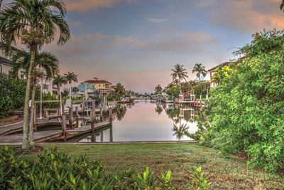 Sunrise over a waterway leading to the ocean near vanderbilt beach in naples, florida.