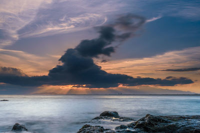 Scenic view of sea against sky at sunset