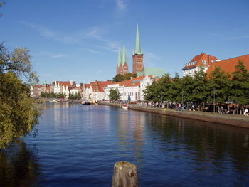 View of canal amidst buildings against sky