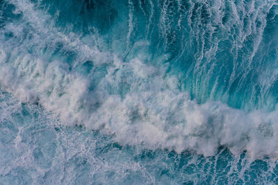 Aerial view of waves splashing in sea
