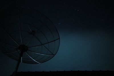 Low angle view of satellite dish against night sky