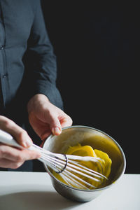 Close-up view of chef whisking egg