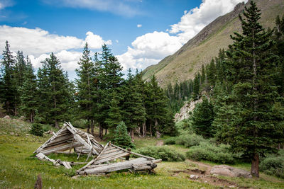 Damaged built structure by mountains against sky