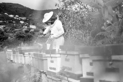 Side view of man working on plants