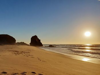 Scenic view of sea against clear sky during sunset