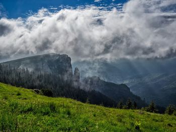 Scenic view of mountains against cloudy sky