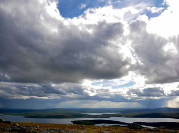 Scenic view of landscape against cloudy sky