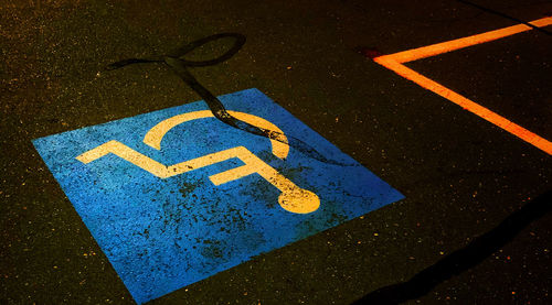 High angle view of road sign over asphalt