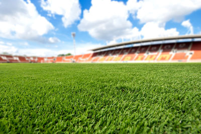 Surface level of soccer field against sky